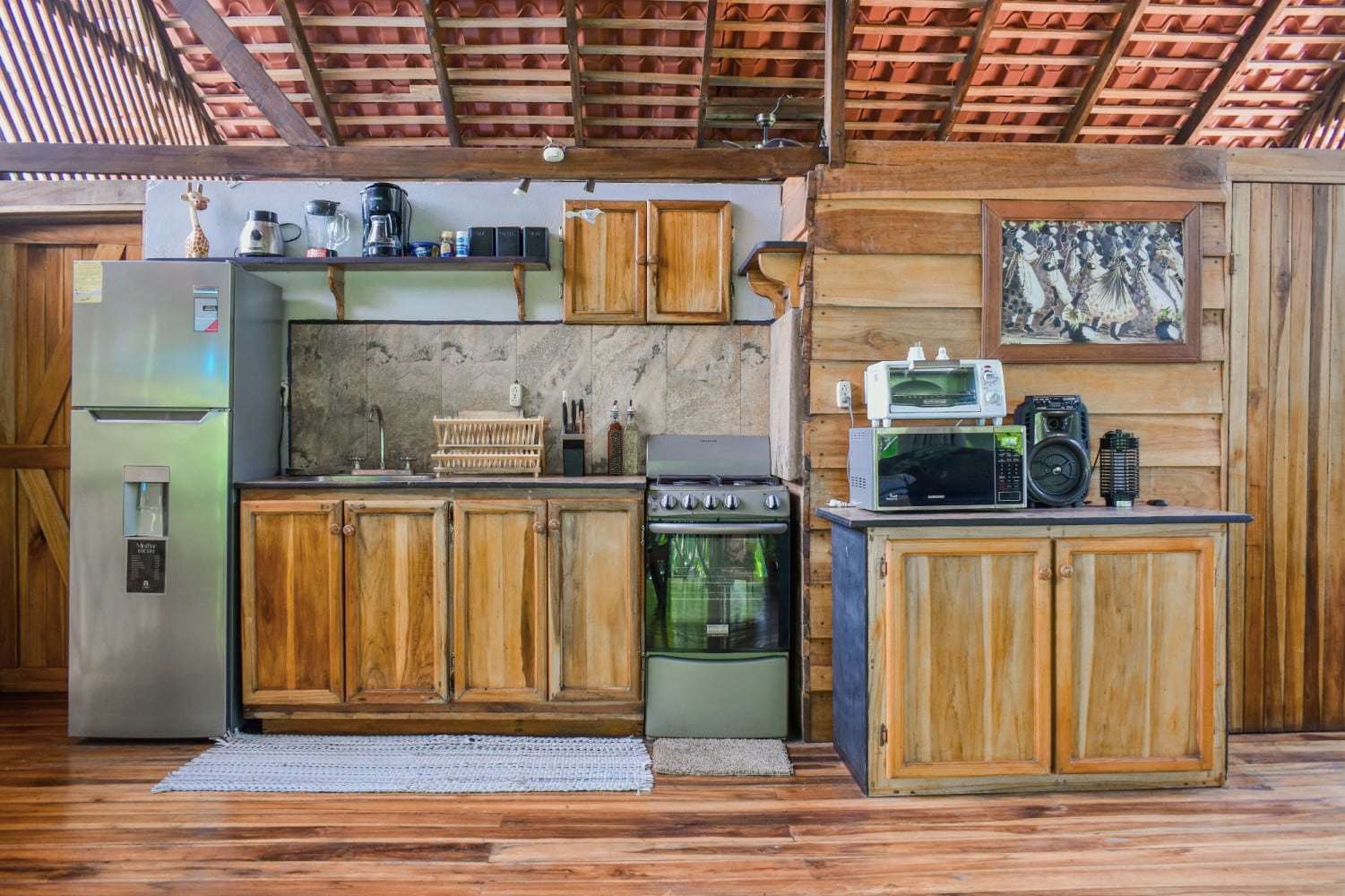 Garden Home full kitchen: fridge, gas range, wooden cabinets, microwave and coffee maker